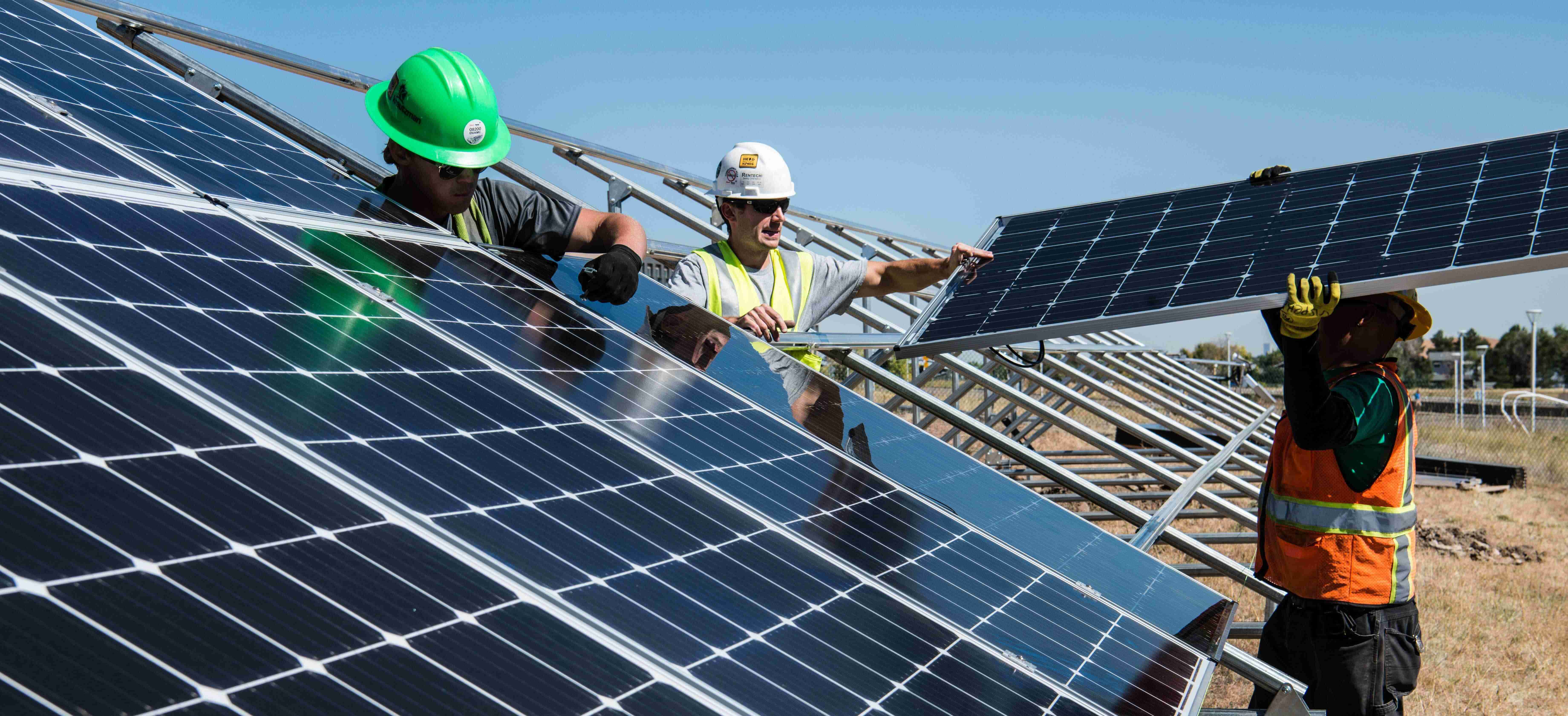 Installers working on a rooftop solar array
