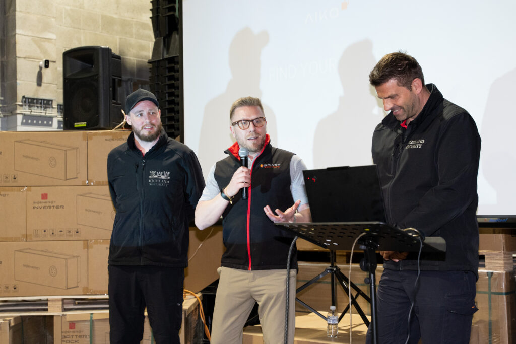 Smart Energy Answers CEO, Daniel, speaking alongside Vahan Verisan, owner of Highland Security Services, and a member of his team at the Smart Energy Innovation Showcase.